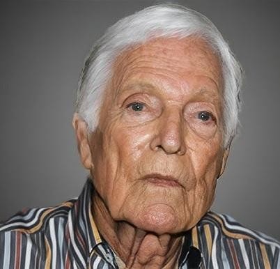 Młody Richard Chamberlain w eleganckim ubraniu, z zamyśloną miną, symbolizujący początki jego kariery aktorskiej.